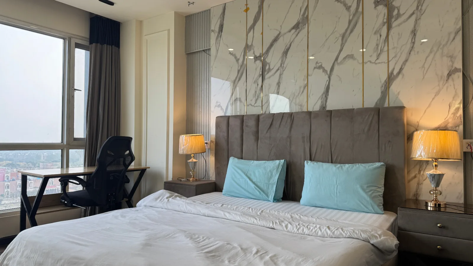 Executive bedroom with workspace and city view at Elysium Tower Islamabad — ideal for business travelers
